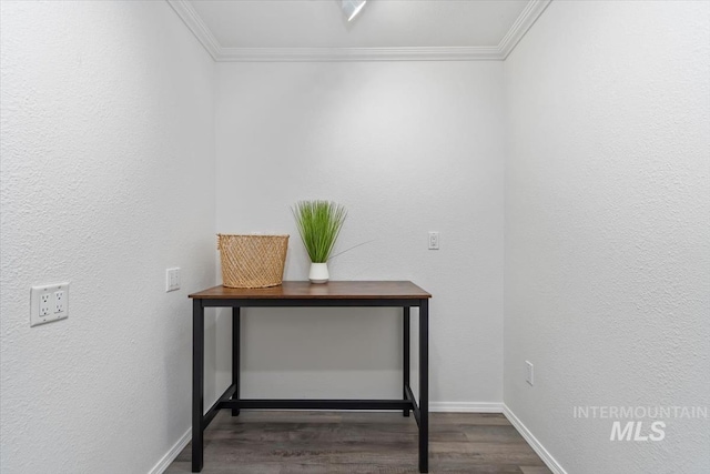 room details with baseboards, wood finished floors, ornamental molding, and a textured wall