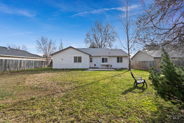 back of property with a patio, a yard, and a fenced backyard