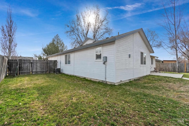 rear view of property with a patio, a yard, a fenced backyard, and cooling unit