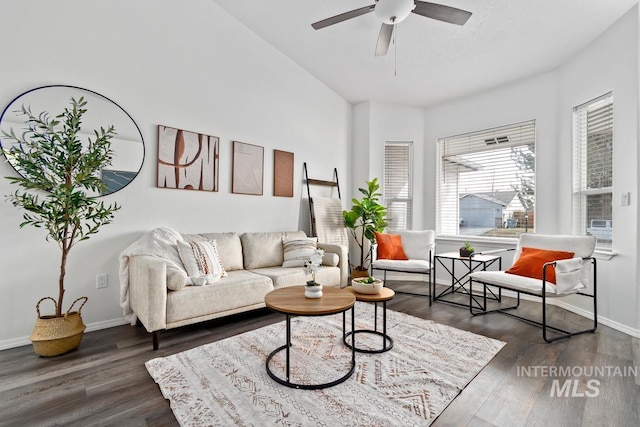 living room featuring ceiling fan, dark wood-type flooring, and baseboards