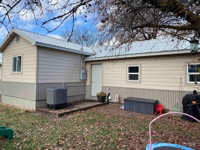 back of house featuring cooling unit