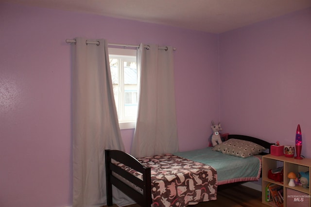 bedroom with hardwood / wood-style floors