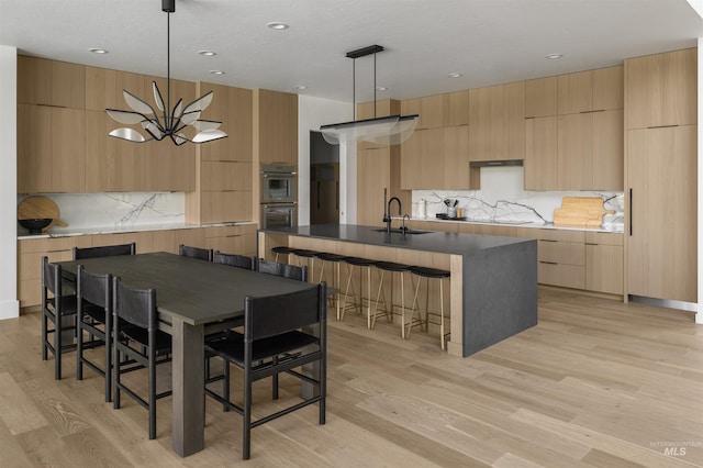 dining area featuring recessed lighting and light wood-style floors