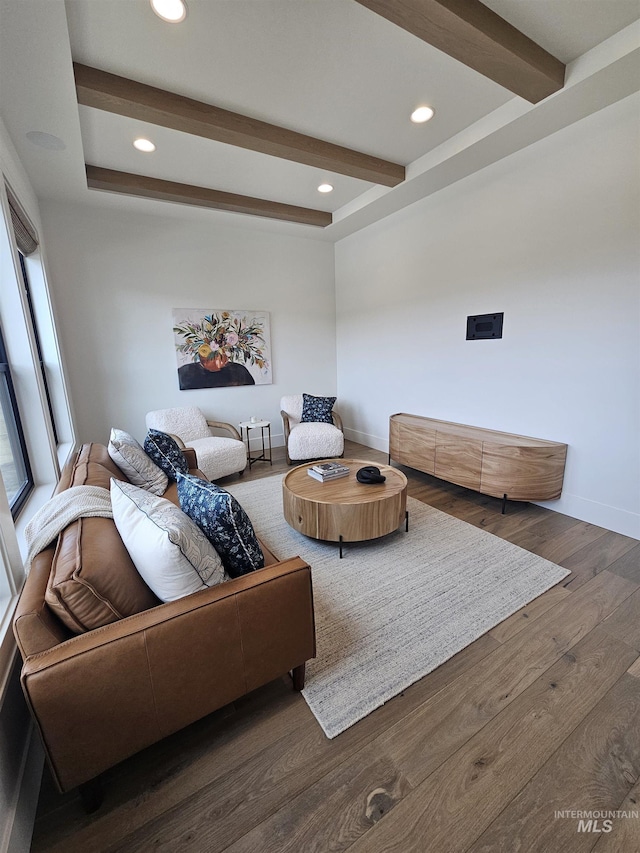 living area with wood finished floors, recessed lighting, beamed ceiling, and baseboards