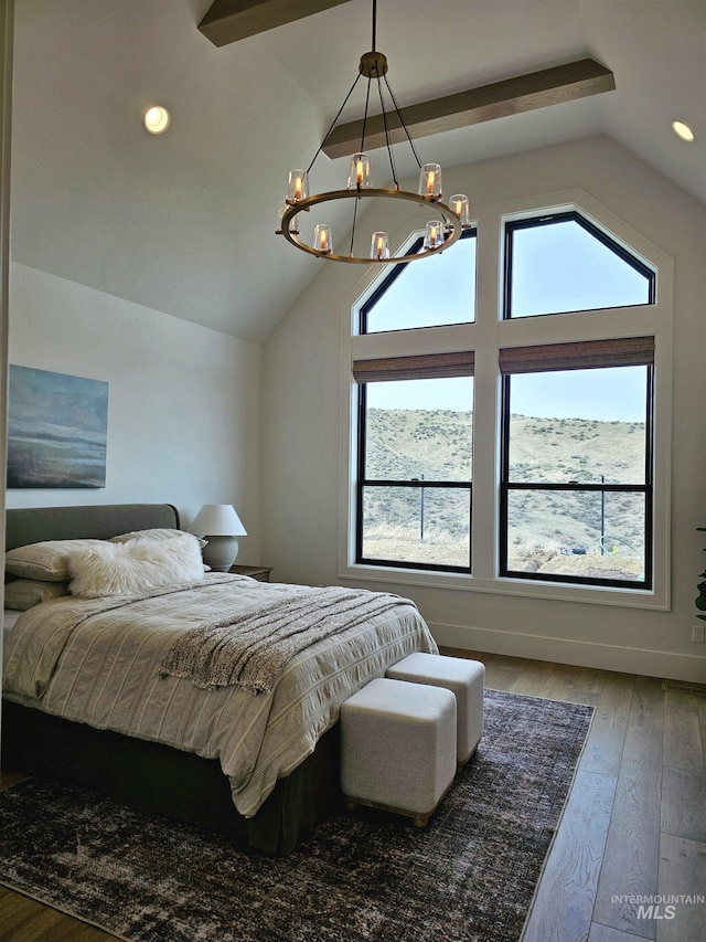 bedroom with a chandelier, wood-type flooring, multiple windows, and lofted ceiling
