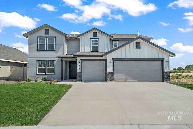 view of front of home with a front yard and a garage