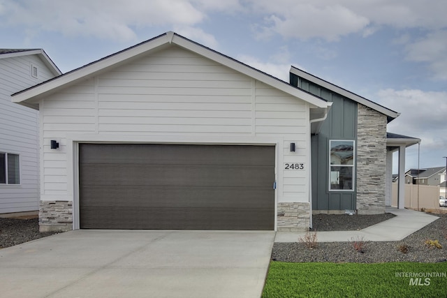 2260 W Balboa St, Kuna, ID 83634 - view of front of property featuring stone siding, concrete driveway, board and batten siding, and an attached garage