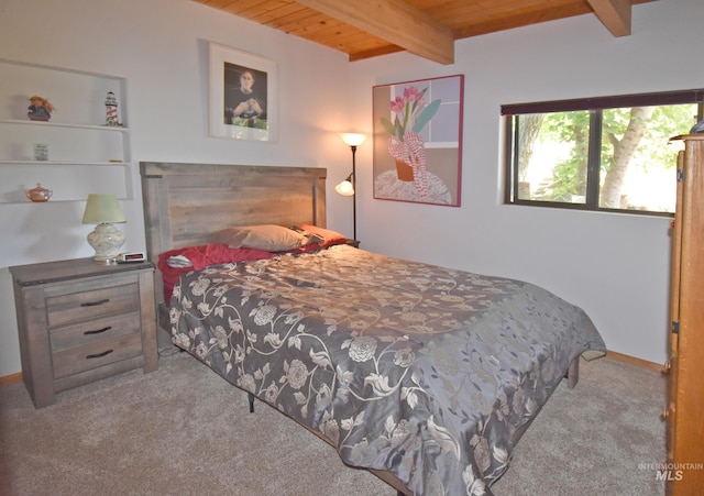 bedroom featuring beamed ceiling, light colored carpet, and wooden ceiling