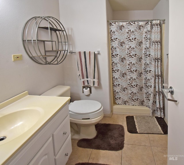 bathroom featuring toilet, a shower with curtain, vanity, and tile patterned floors