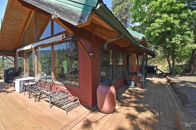 wooden terrace with a sunroom