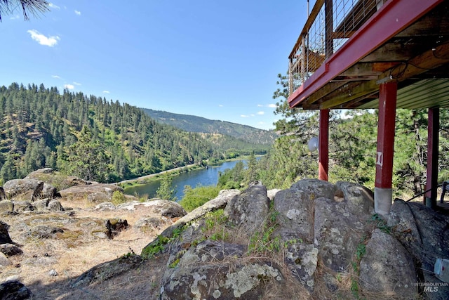 exterior space with a water and mountain view