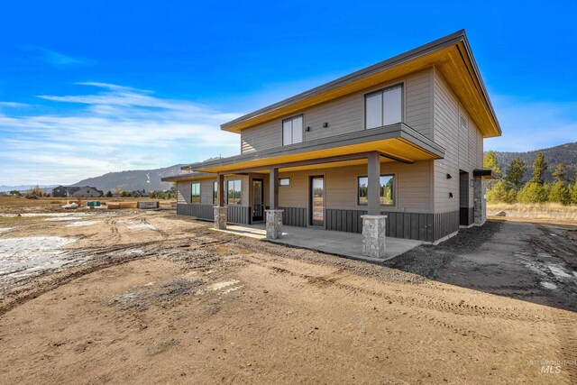 13156 Hawks Bay, Donnelly, ID 83615 - back of property featuring a mountain view and covered porch