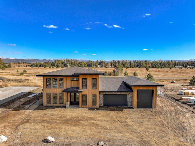 13156 Hawks Bay, Donnelly, ID 83615 - prairie-style home featuring an attached garage, a mountain view, dirt driveway, and a shingled roof
