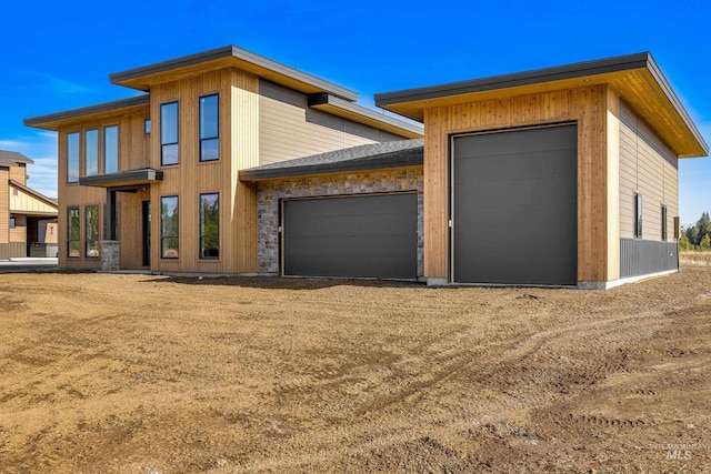 13156 Hawks Bay, Donnelly, ID 83615 - view of front of home featuring an attached garage and dirt driveway