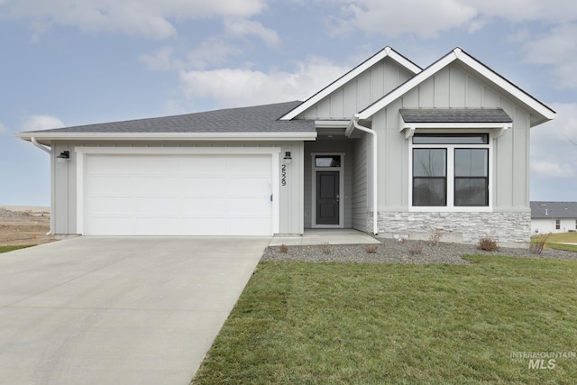 view of front facade featuring an attached garage, concrete driveway, a front lawn, stone siding, and board and batten siding