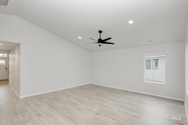 empty room featuring ceiling fan, light hardwood / wood-style flooring, and lofted ceiling