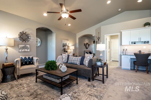 living room featuring arched walkways, recessed lighting, light colored carpet, a ceiling fan, and vaulted ceiling