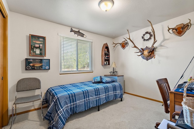 bedroom featuring baseboards and carpet flooring