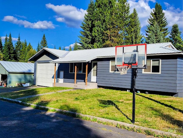 ranch-style home featuring metal roof and a front yard