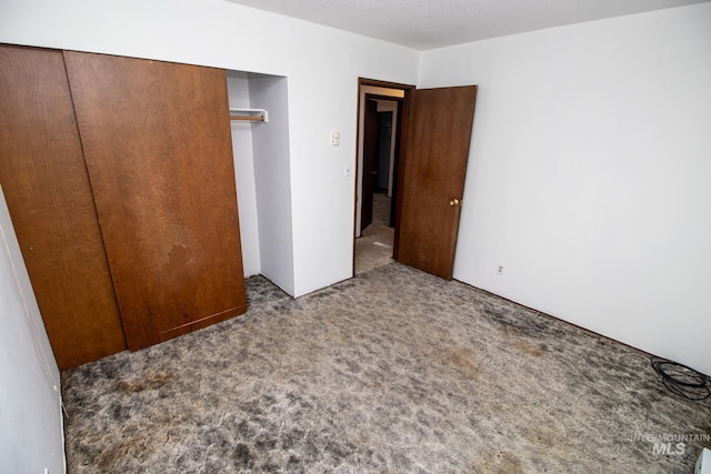 unfurnished bedroom with carpet and a closet