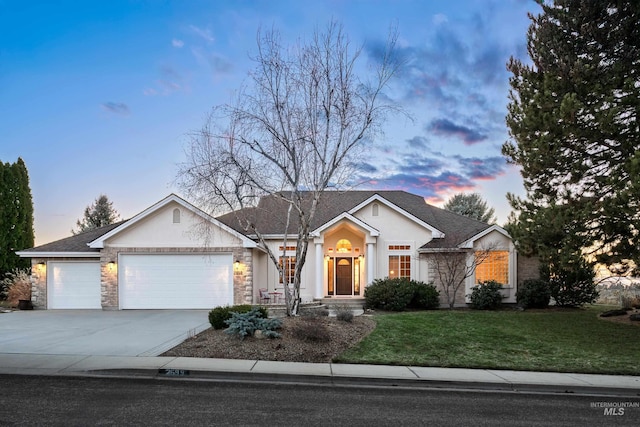 ranch-style home with a garage, driveway, a front lawn, and stucco siding