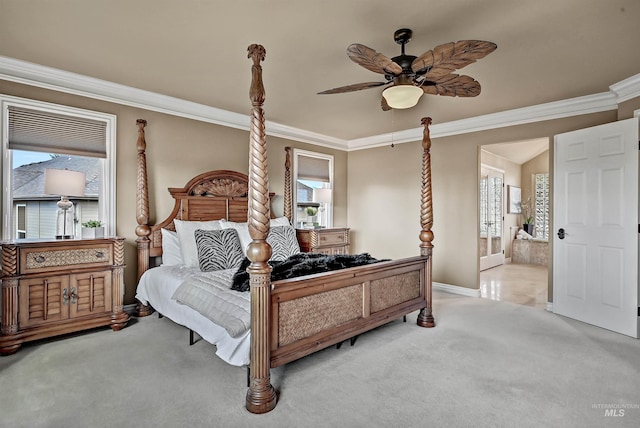 bedroom featuring crown molding, a ceiling fan, carpet flooring, ensuite bath, and baseboards