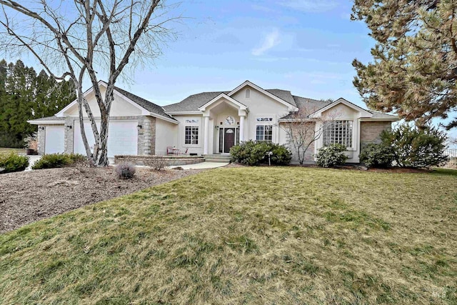 single story home with a garage, a front lawn, and stucco siding