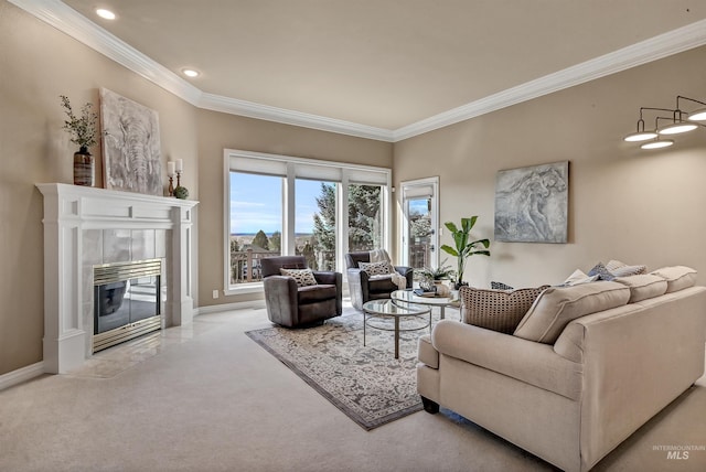 living area featuring a tiled fireplace, ornamental molding, carpet, and baseboards