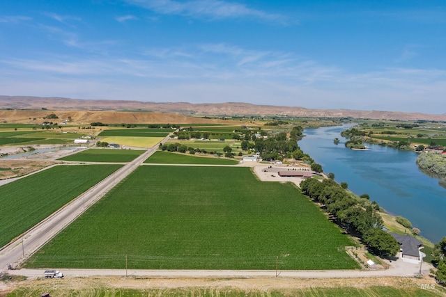 aerial view with a water and mountain view and a rural view