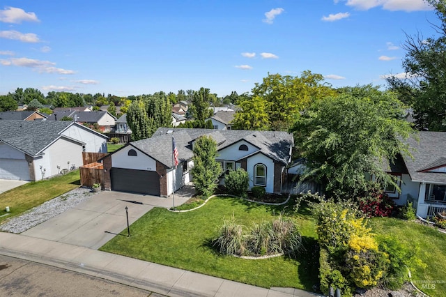 8116 Waterleaf Ave, Nampa, ID 83687 - ranch-style house with a residential view, a front lawn, concrete driveway, and an attached garage