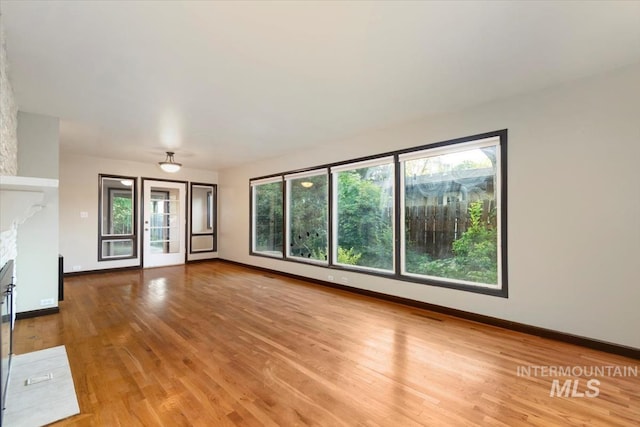 6917 W Randolph Dr, Boise, ID 83709 - unfurnished living room featuring wood finished floors and baseboards