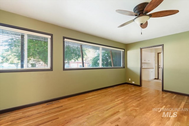 6917 W Randolph Dr, Boise, ID 83709 - unfurnished room featuring light wood-style flooring, a ceiling fan, and baseboards