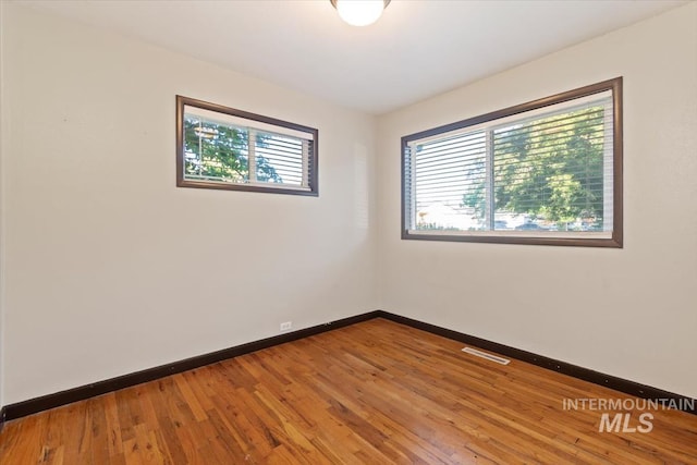 6917 W Randolph Dr, Boise, ID 83709 - empty room with baseboards and wood finished floors
