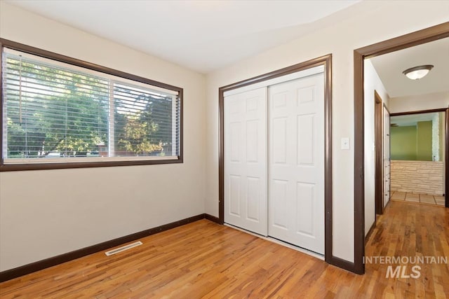 6917 W Randolph Dr, Boise, ID 83709 - unfurnished bedroom featuring multiple windows, baseboards, and light wood-style floors
