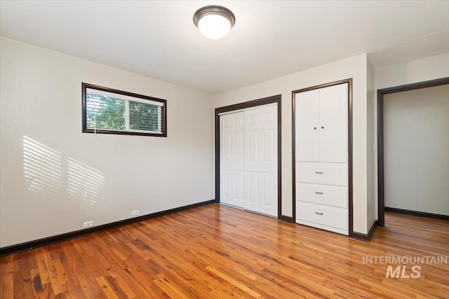 6917 W Randolph Dr, Boise, ID 83709 - unfurnished bedroom with light wood-style flooring, baseboards, and multiple closets
