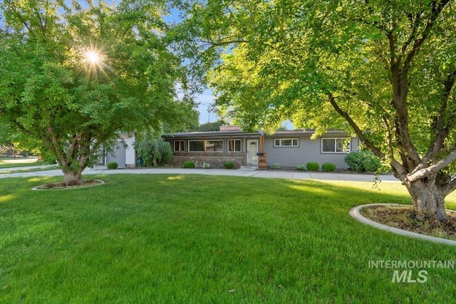 6917 W Randolph Dr, Boise, ID 83709 - ranch-style home with a front lawn and a garage
