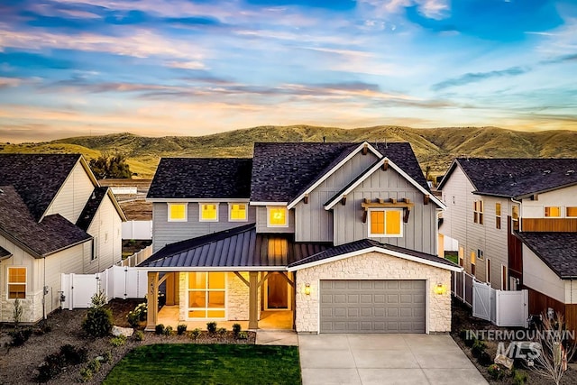 modern farmhouse style home featuring a mountain view and a garage