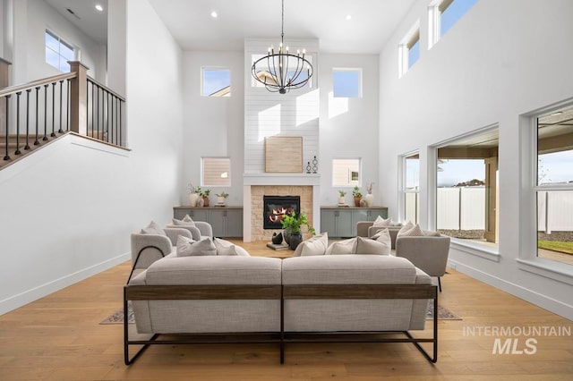 living room featuring a wealth of natural light, a high ceiling, and light wood-type flooring