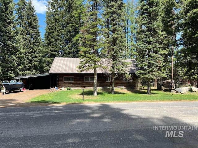 329 Forest St, Mccall, ID 83638 - cabin with a carport, concrete driveway, and a front yard