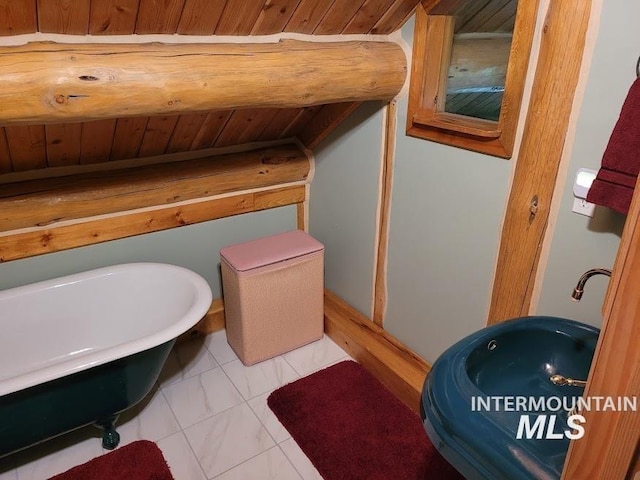 bathroom with a washtub, tile patterned flooring, and wood ceiling