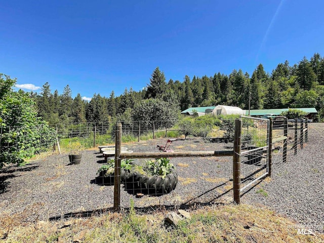 view of yard featuring an outbuilding and a rural view