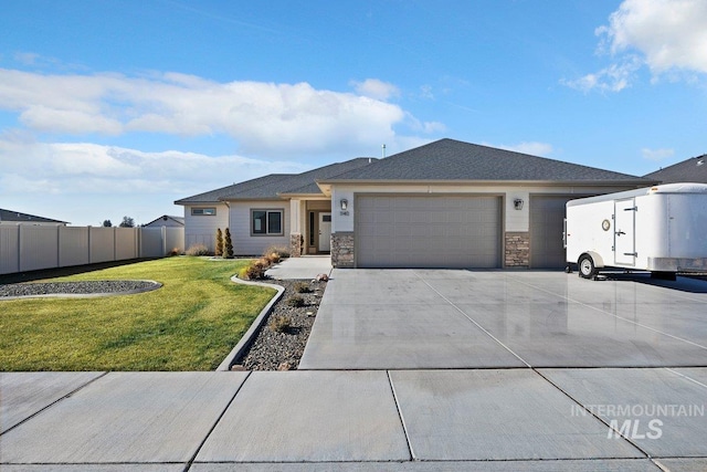 view of front of house with a garage and a front lawn