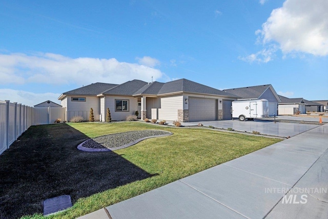 view of front of house with a garage and a front lawn