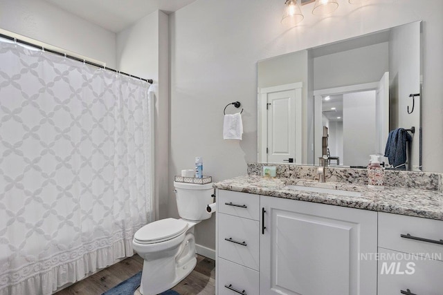 bathroom featuring a shower with shower curtain, vanity, toilet, and hardwood / wood-style floors