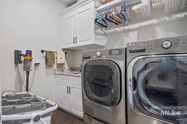 laundry room with cabinets and separate washer and dryer