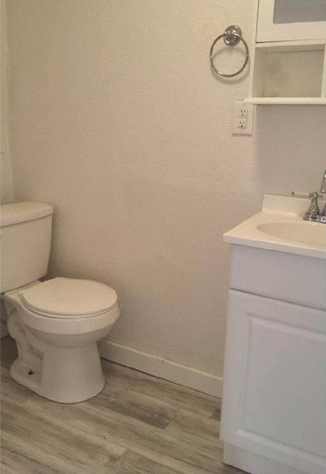 3377 W Nez Perce St, Boise, ID 83705 - bathroom featuring wood finished floors, vanity, toilet, and baseboards