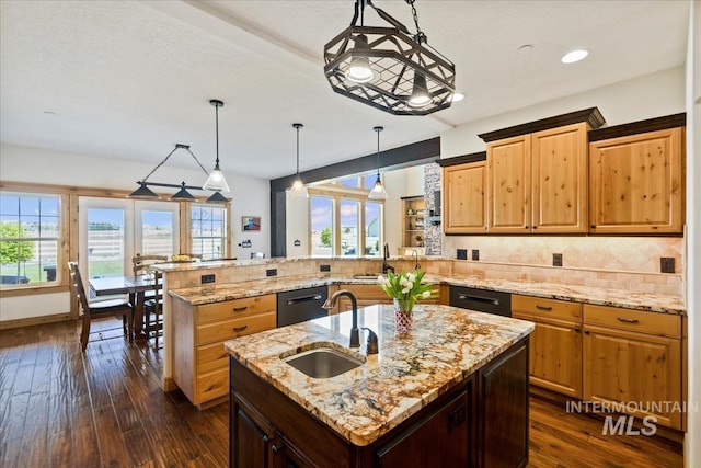 kitchen featuring dark wood-type flooring, a sink, a peninsula, and dishwasher