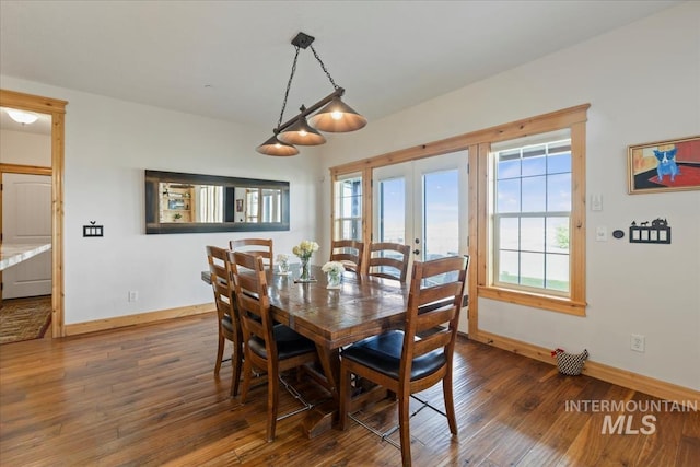 dining area featuring baseboards, a healthy amount of sunlight, french doors, and hardwood / wood-style flooring