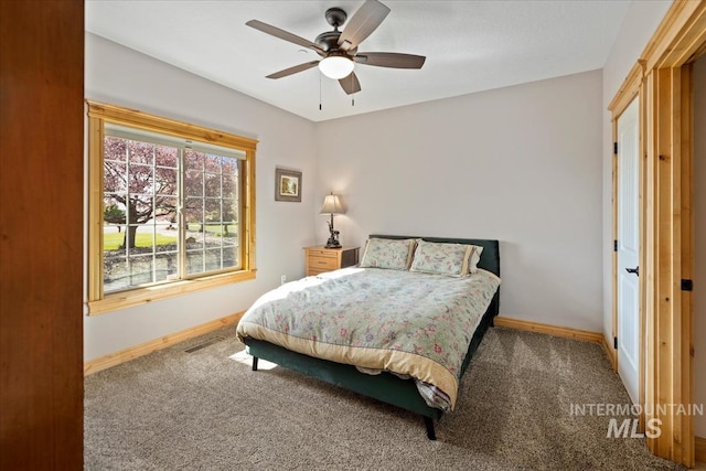 bedroom with carpet flooring, a ceiling fan, and baseboards