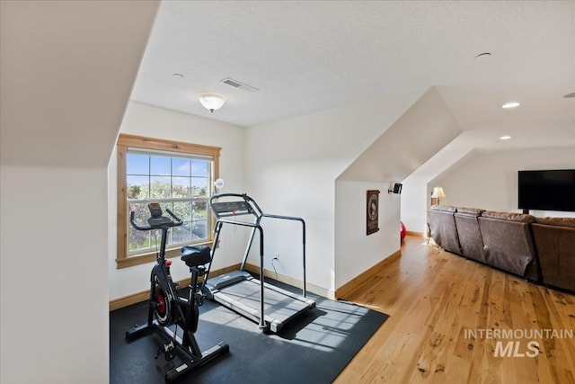 workout room featuring visible vents, recessed lighting, baseboards, and wood finished floors